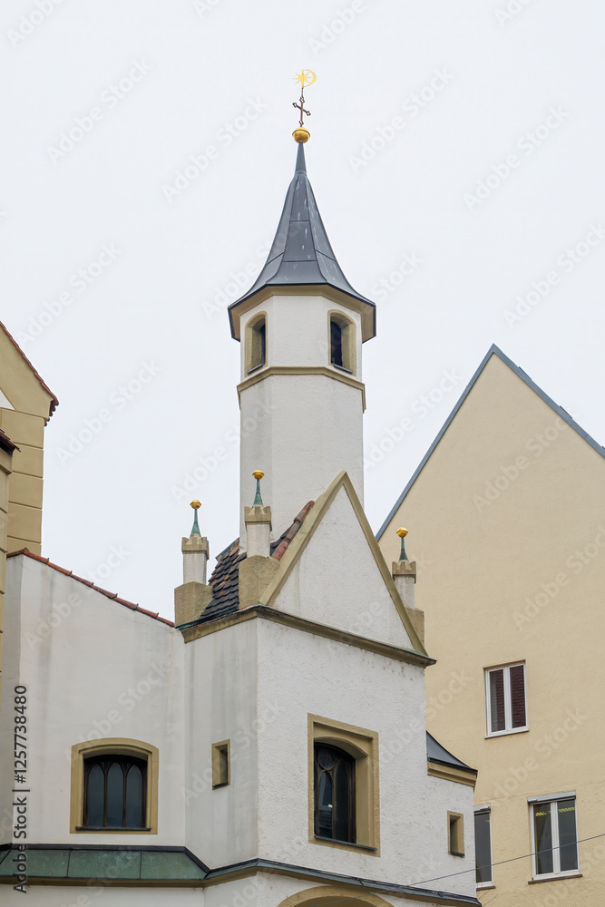 Fototapeta premium Small historic chapel with pointed tower in Augsburg, Germany, 10.02.2025