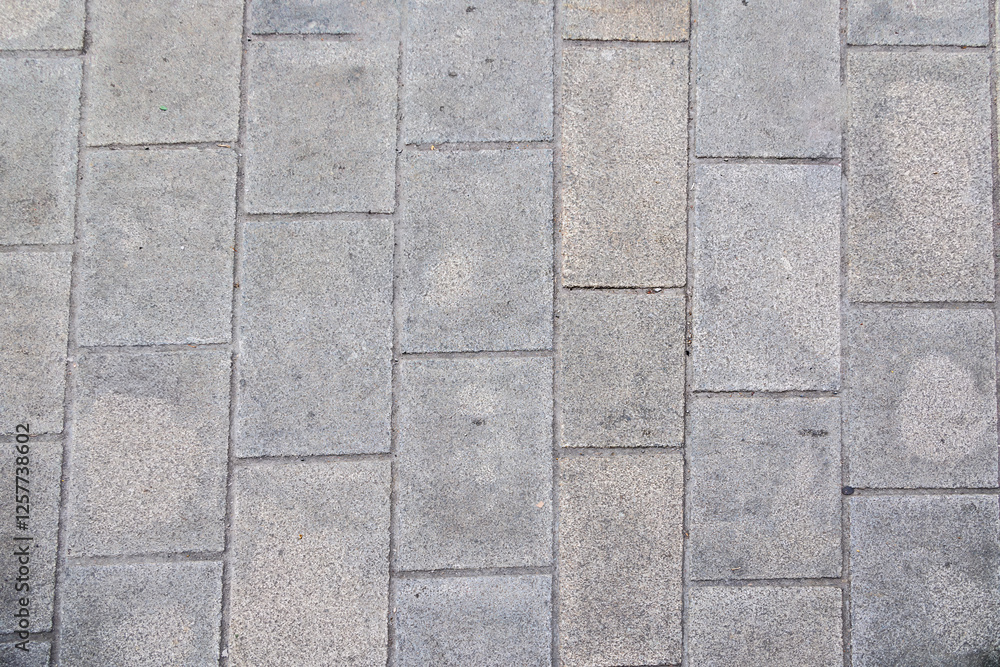 Naklejka premium Close-up of Grey Stone Pavement Texture, Augsburg, Germany, 10.02.2025