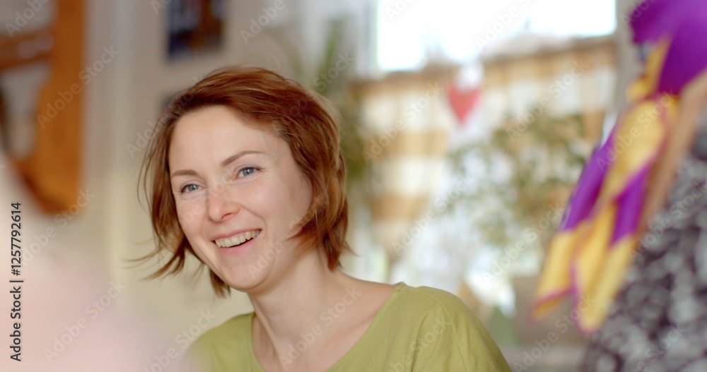 In a bright room with warm light, a smiling woman with short, reddish hair creates a cheerful atmosphere, making it perfect for friends to gather and enjoy delightful interactions In a bright room with warm light, a smiling woman with short, reddish hair creates a cheerful atmosphere, making it perfect for friends to gather and enjoy delightful interactions