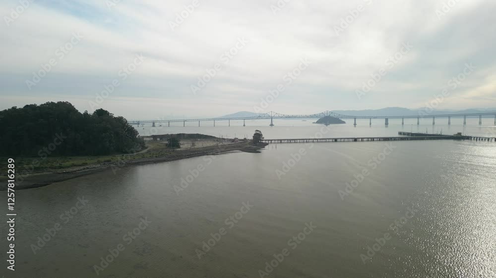 High-altitude aerial view of the Richmond–San Rafael Bridge near the scenic Point Molate Beach. High-altitude aerial view of the Richmond–San Rafael Bridge near the scenic Point Molate Beach.