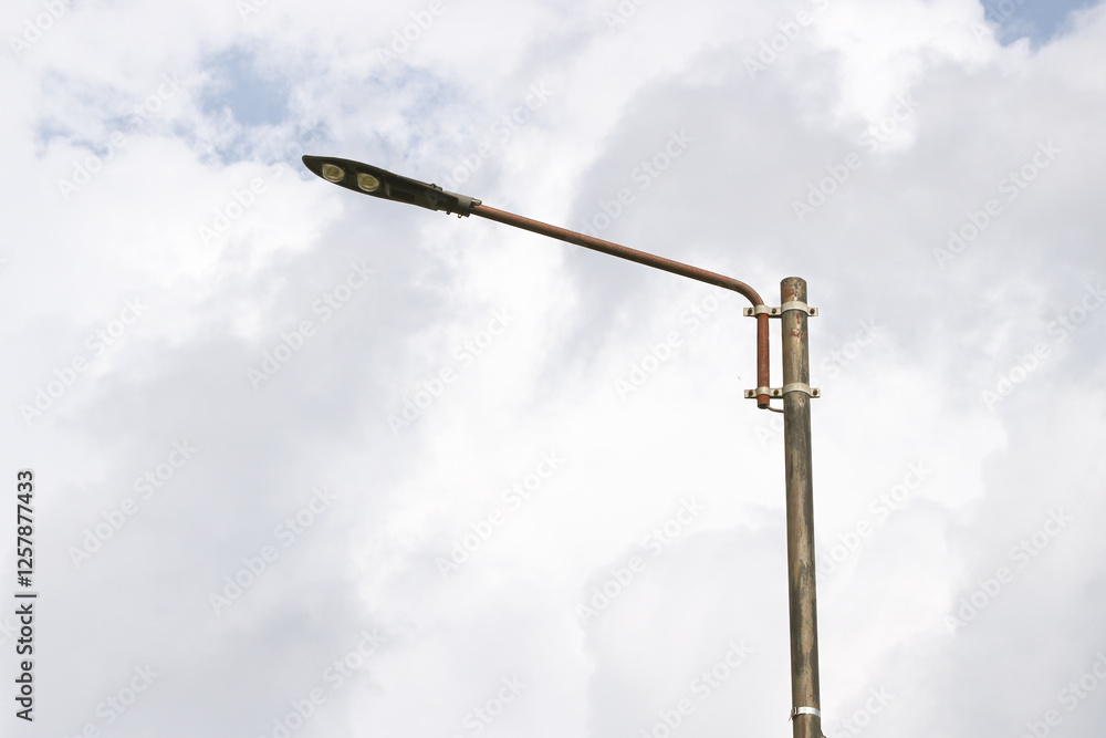 Automatic street lamp pole with solar panel system over the clear blue sky background Automatic street lamp pole with solar panel system over the clear blue sky background