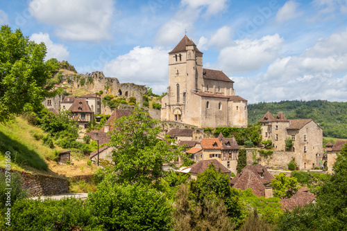 Fotografie Old cliffside village of Saint-Cirq-Lapopie and his church in the Occitanie regi