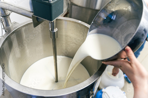 Stirring sour cream. Production of dairy products, butter and sour cream. Stirring sour cream. Production
