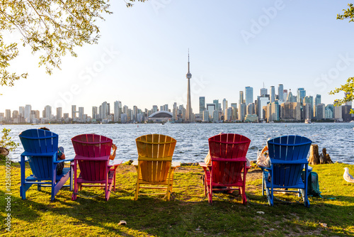 Canvas Print Colorful adirondack chairs on Toronto Island Park at sunset time