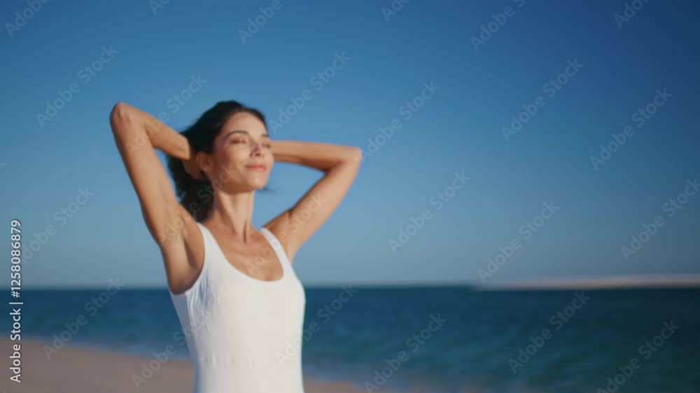 Woman enjoying marine nature raising hands to clear sky on sunny beach closeup. Woman enjoying marine nature raising hands to clear sky on sunny beach closeup.