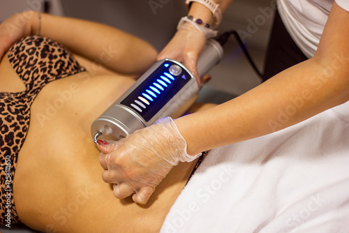 Massage therapist cosmetologist does anti-cellulite massage with Endosfera device, modern skin and body care, lymph acceleration, selective focus