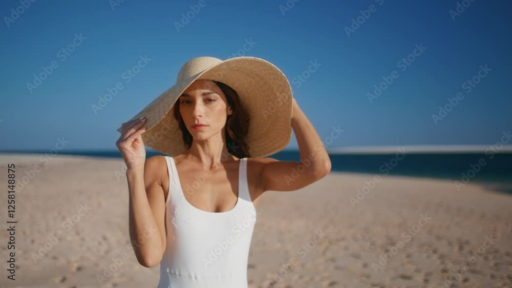 Stylish model posing beach wearing straw hat closeup. Gorgeous woman on shore Stylish model posing beach wearing straw hat closeup. Gorgeous woman on shore