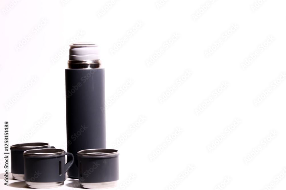 Thermos bottle isolated on white background. Aluminum can. Thermos and metal cups of coffee. Thermos bottle isolated on white background. Aluminum can. Thermos and metal cups of coffee.