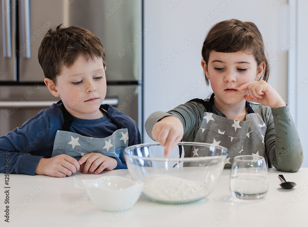Siblings Learning to Bake in a Modern Kitchen Setting Siblings Learning to Bake in a Modern Kitchen Setting