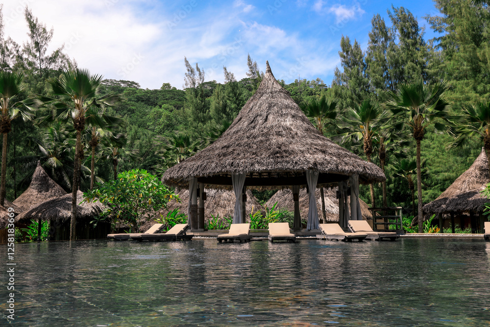Relaxing poolside view at a tropical resort in Seychelles surrounded by lush greenery Relaxing poolside view at a tropical resort in Seychelles surrounded by lush greenery