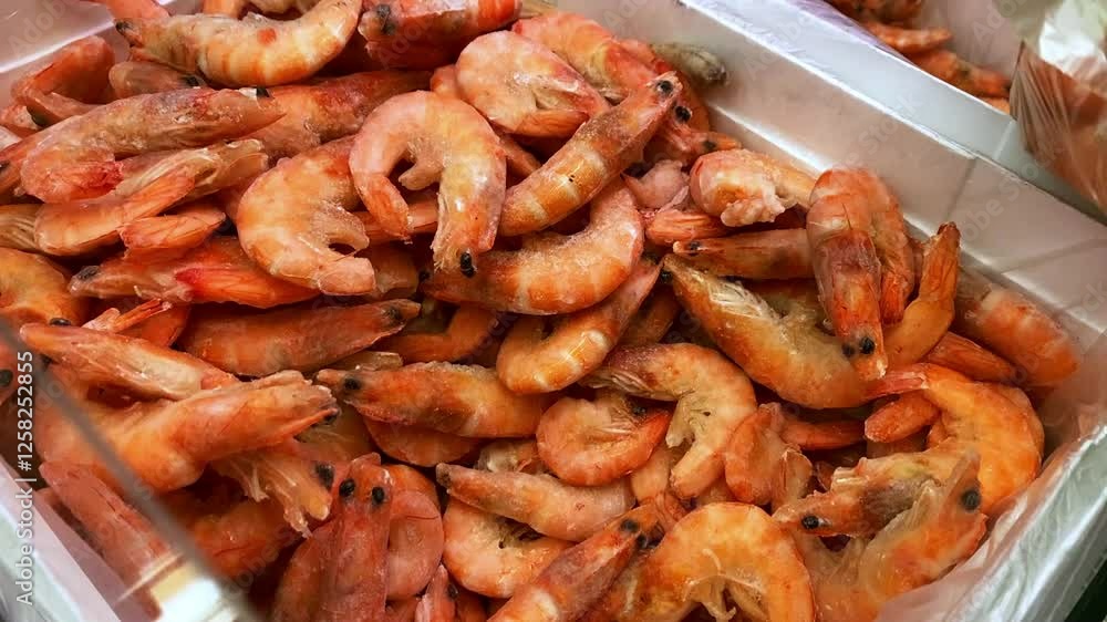 A vibrant and enticing display of freshly cooked shrimp captured in a bustling seafood market, making it an ideal choice for various culinary applications and stunning food photography