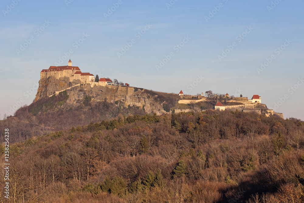 Sunset view of the medieval Regiersburg castle, a famous landmark and tourist spot in Austria Sunset view of the medieval Regiersburg castle, a famous landmark and tourist spot in Austria