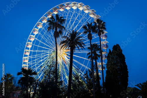 Funfair wheel at dusk in the french riviera. photo