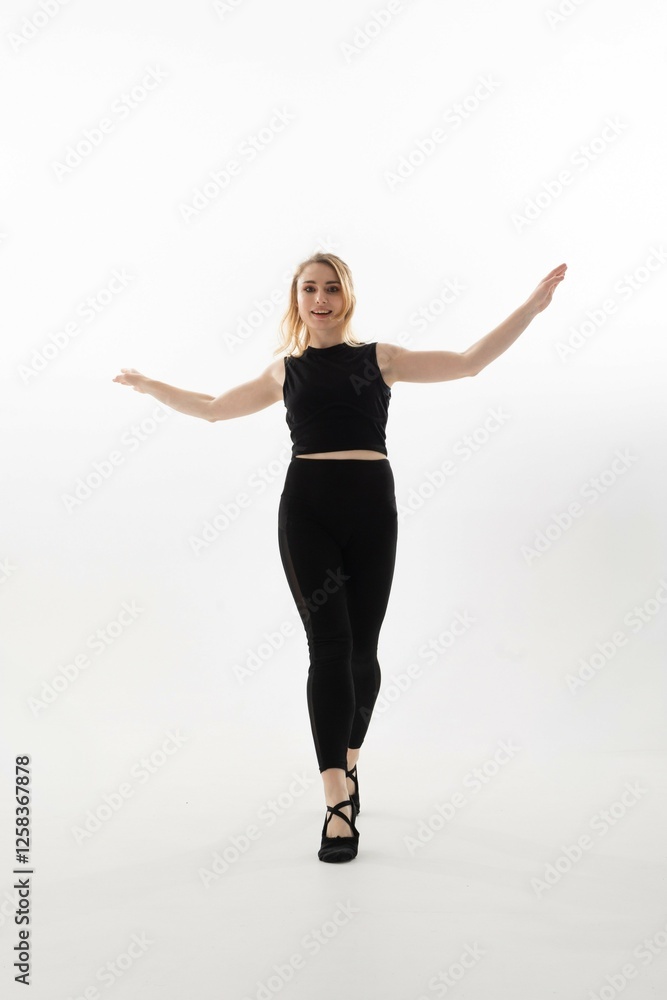 Obraz premium Woman performing a dance pose against a bright background while showcasing graceful movements and expressions
