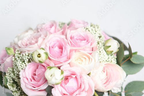 Beautiful bouquet of pink roses and ranunculus. stylish wedding attributes of bride. blooming flowers festive background, pastel and soft bouquet floral card