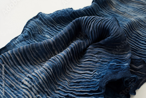 Obraz na płótnie Soft, crinkled Japanese shibori-dyed textile, deep indigo with organic, tie-dye wave patterns. w salonie