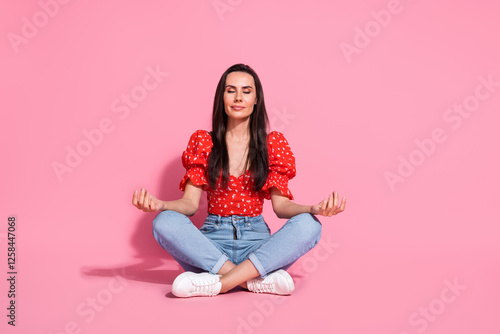 Full size photo of pretty young woman sit floor meditate wear top isolated on pink color background