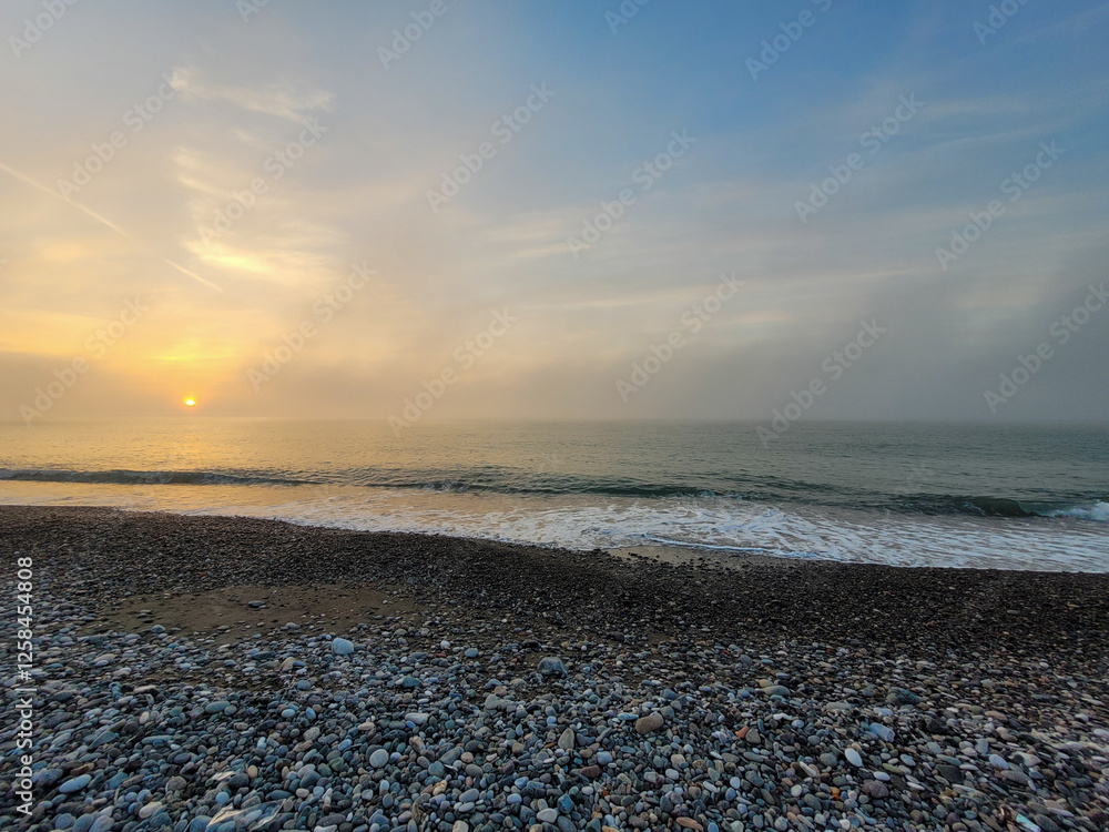 Expansive View of Pebble Beach and Ocean at Sunset Expansive View of Pebble Beach and Ocean at Sunset