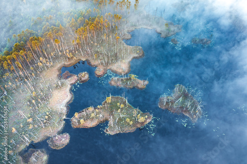 Obraz na płótnie Drone panorama on tiny isles in lake in colorful sunrise colors. Top down view on swamp with isle. Sustainable ecosystem of wetlands. w salonie