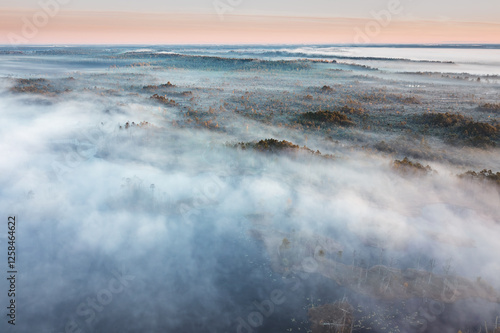 Obraz na płótnie Drone panorama on tiny isles in lake in colorful sunrise colors. Top down view on swamp with isle. Sustainable ecosystem of wetlands. w salonie