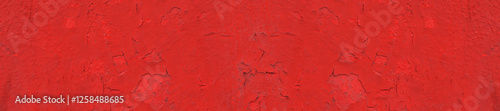Red Wall With Cracks and Textured Paint Detailas background.