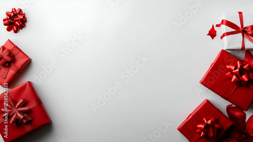 A collection of beautifully wrapped red gifts arranged stylishly on a neutral background for festive celebrations.