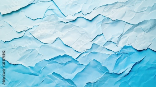 A visually striking abstract background featuring textured layers of paper, showcasing subtle shades of blue, ideal for various design projects.