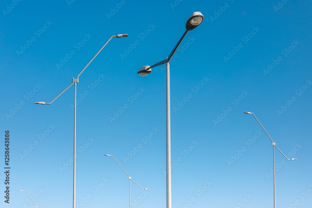 Street Lights Against Clear Blue Sky – Urban Infrastructure, Minimalist Cityscape, and Modern Lighting Street Lights Against Clear Blue Sky – Urban Infrastructure, Minimalist Cityscape, and Modern Lighting