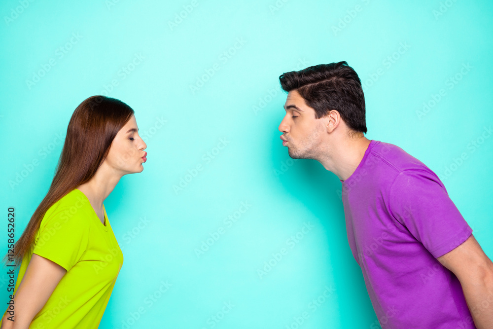 Profile side view portrait of his he her she nice attractive dreamy affectionate couple leaning kissing isolated over bright vivid shine vibrant green turquoise background Profile side view portrait of his he her she nice attractive dreamy affectionate couple leaning kissing isolated over bright vivid shine vibrant green turquoise background