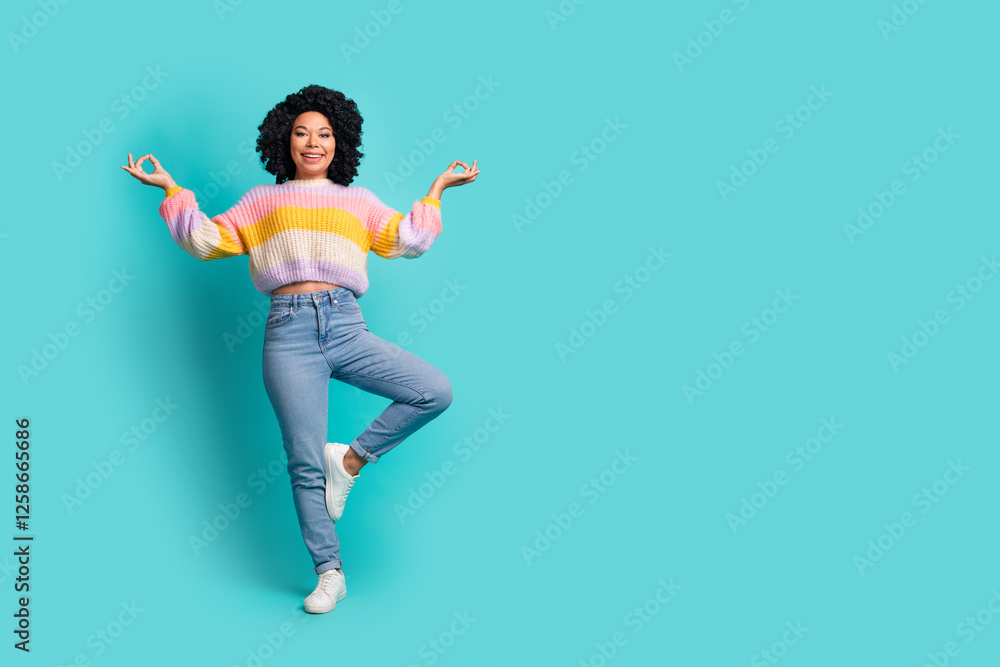 Smiling young woman in colorful casual outfit practicing mindfulness against teal background Smiling young woman in colorful casual outfit practicing mindfulness against teal background