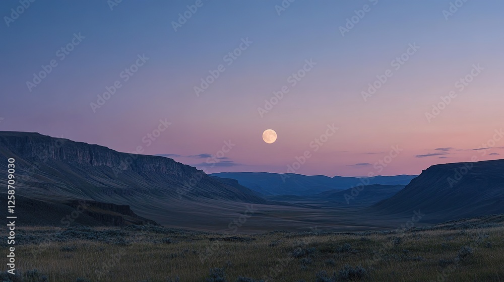 Fototapeta premium Moonlit landscape over a vast mountain valley at dusk
