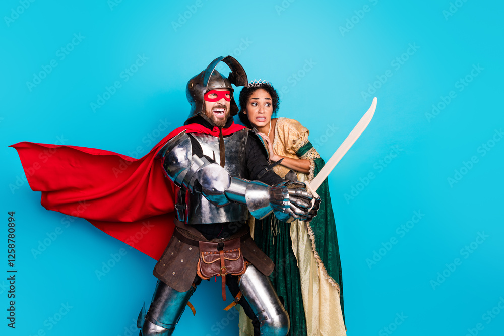 Naklejka premium Playful Couple in Medieval Knight and Princess Costumes Against a Vibrant Pink Background