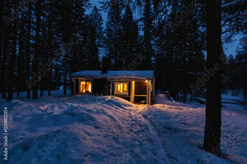 Obraz na płótnie Cozy wooden cabin in a snow-covered forest in the north of Sweden, Kiruna w salonie