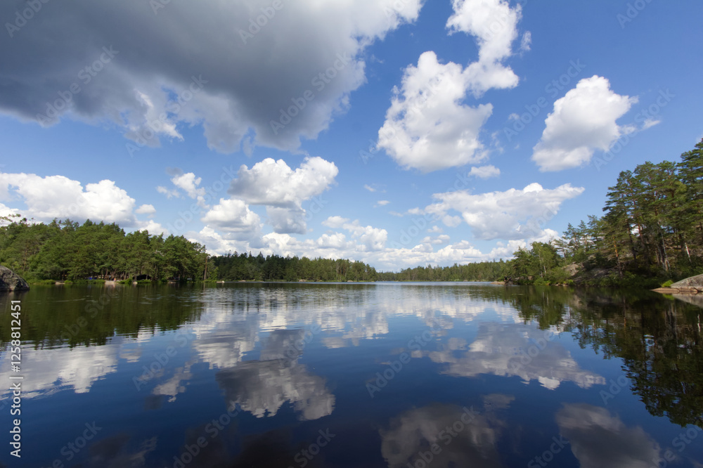 Clouds mirrored in a lake in the Swedish national park Tyresta By near Stockholm