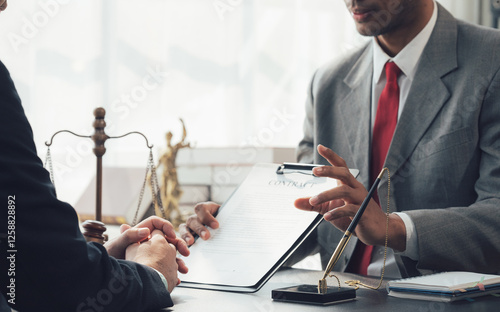 A Deal Sealed with a Handshake: A confident businessman and businesswoman, dressed in professional attire, shake hands over a table strewn with financial documents and a potted plant. photo