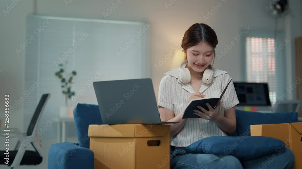 Young entrepreneur managing her online business from home Young entrepreneur managing her online business from home