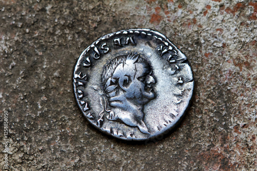 Roman silver denarius coin showing portrait of emperor Flavius Vespasianus