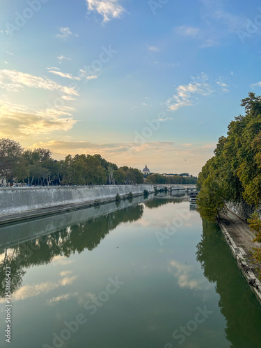 A stunning dusk view from the Ponte Sisto bridge in Rome, where the soft glow of twilight casts a magical reflection over the Tiber River. photo