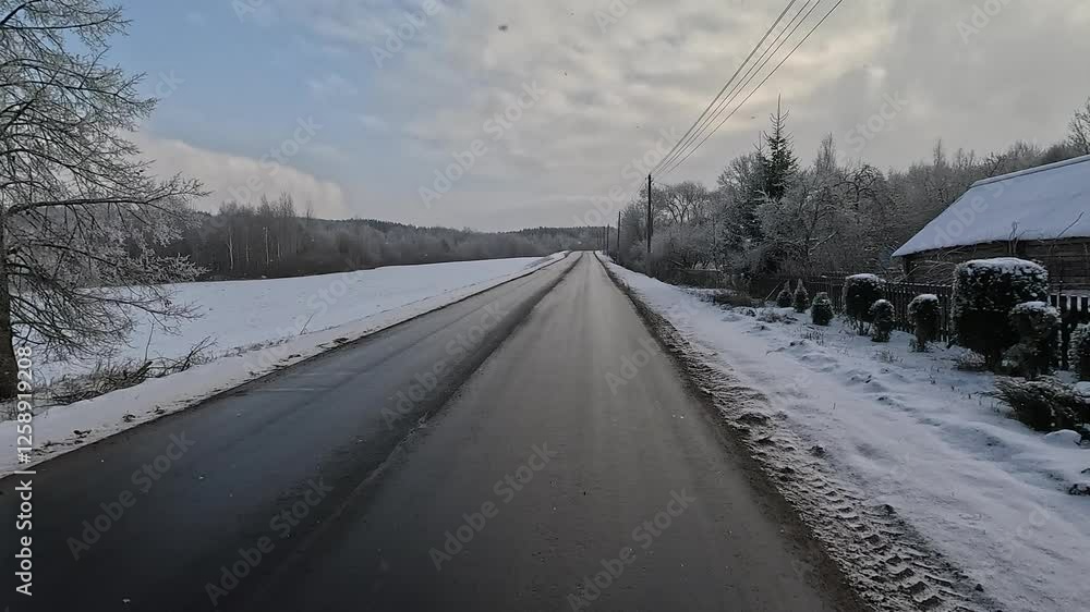 Winter road with snow, highway with cars on a sunny winter day. Winter landscape, road and shoulder covered with snow.