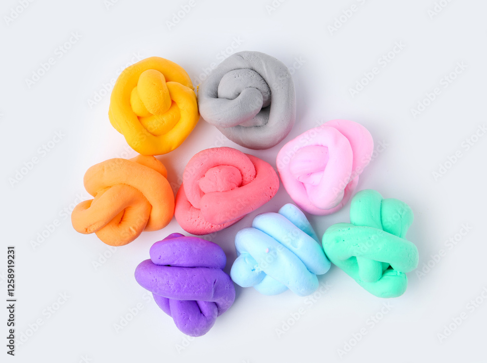Fototapeta premium Different colorful play dough on white background, flat lay