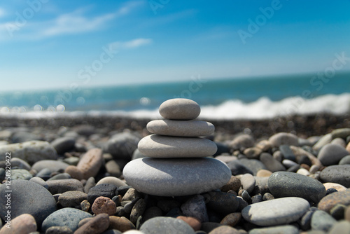 Canvas Print smooth white stones on the seashore stacked in a pyramid, zen, relaxation, yoga,