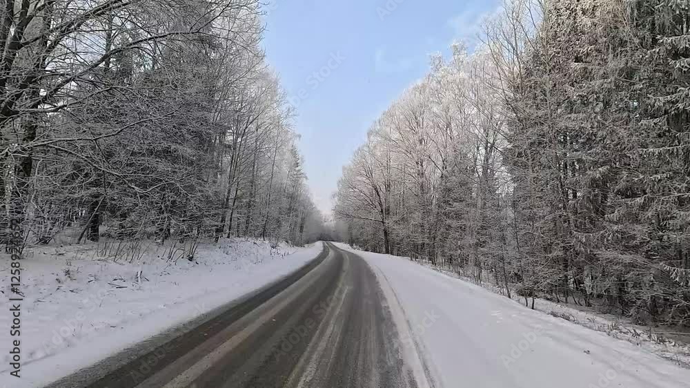Winter road with snow, highway with cars on a sunny winter day. Winter landscape, road and shoulder covered with snow. Winter road with snow, highway with cars on a sunny winter day. Winter landscape, road and shoulder covered with snow.