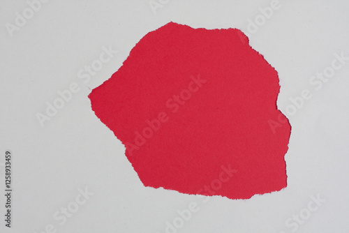 Torn red paper revealing a white background
