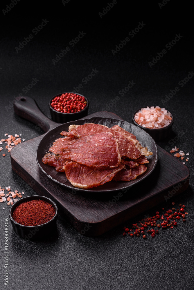 Jerky, dried pork meat slices with salt and spices Jerky, dried pork meat slices with salt and spices