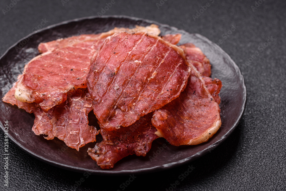 Jerky, dried pork meat slices with salt and spices Jerky, dried pork meat slices with salt and spices