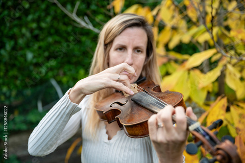 Woman playing violing with her fingers photo