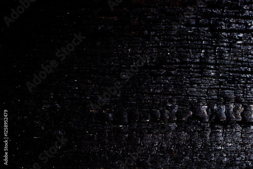 Close-up black and silver background texture of burnt wood.