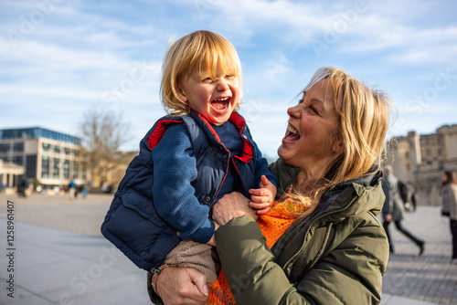 Grandmother and grandson laughing together in Tower of London square