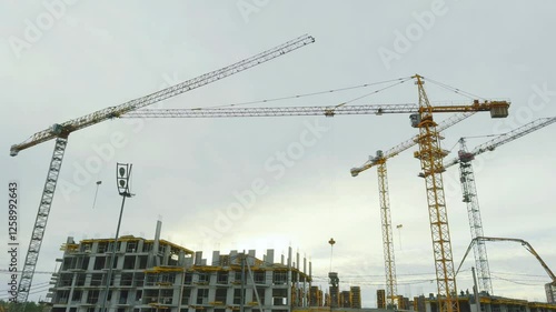 Aerial view of house construction with crane and workers in action, showcasing urban development, heavy machinery, and modern building processes. Ideal for real estate projects. High quality