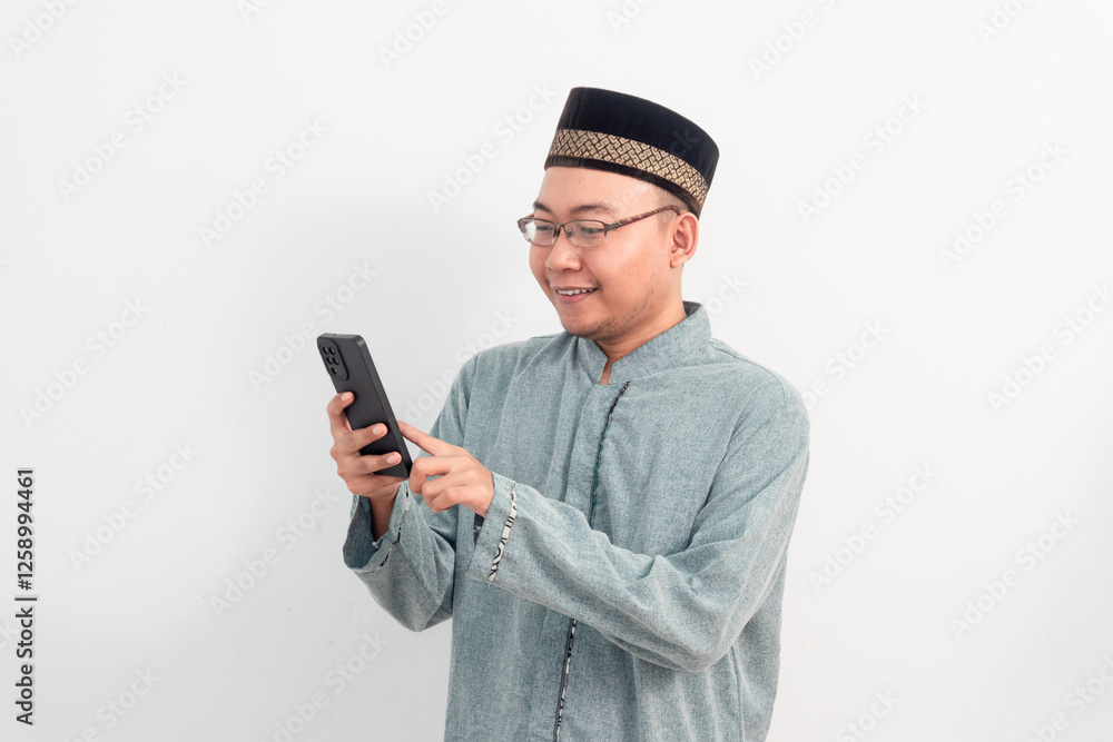 Asian Muslim man wearing white clothes smiling holding phone pose, Ramadan Eid Al Fitr and eid adha days celebration isolated white background. Islamic celebration concept.. Asian Muslim man wearing white clothes smiling holding phone pose, Ramadan Eid Al Fitr and eid adha days celebration isolated white background. Islamic celebration concept..